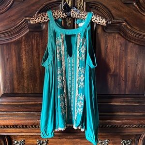 Green and beige cold shoulder shirt.